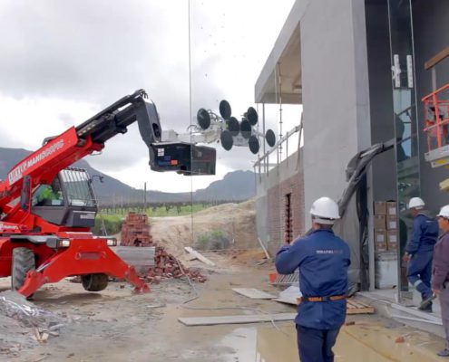 Mobile crane lifting heavy glass