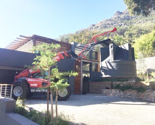 Mobile crane installing a large water tank